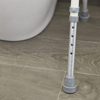 NRS Mowbray Toilet Seat & Frame adjustable metal leg with rubber tip shown on wooden floor, close-up.