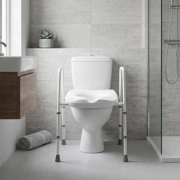 NRS Mowbray Toilet Seat & Frame width adjustable with support rails next to a shower in a modern bathroom, side view.