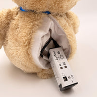 Music Bear Arthur therapeutic teddy bear with open back and removable electronic music player, rear view.
