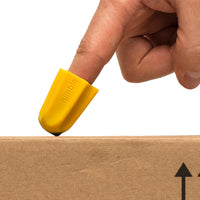 RNIB Nimble One-Finger Cutting Tool with ceramic blade opening a cardboard box, in use view.