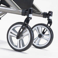 Close-up of two black and silver wheels on the Drive Nitro SL Rollator attached to its aluminium frame, white background, close-up view.