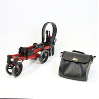 Folded NRS Compact Easy Plus Rollator with height-adjustable handles and black bag, white background, side view.