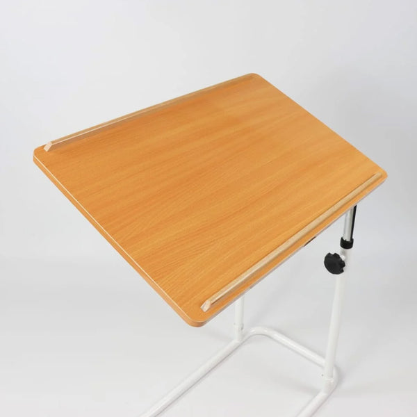 NRS Divan Overbed Table with height adjustment and tilting wooden top, metal legs, plain background, angled view.