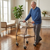Elderly man using NRS Home Helper Wheeled Trolley in a bright living room with plants and wooden floors, in use view.