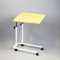 NRS Overbed/Overchair Table with white frame and four castors on plain grey background, angled front view.