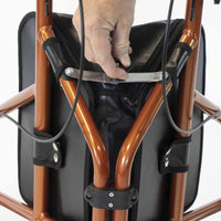 Hand gripping the handle of an NRS Three Wheel Aluminium Rollator walking aid, close-up view.