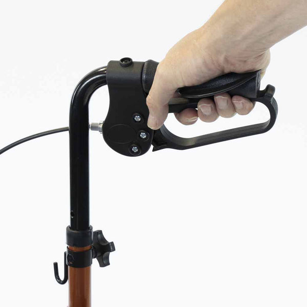 Hand holding NRS Three Wheel Aluminium Rollator handle and brake lever, plain background, close-up.