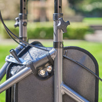 NRS Three Wheel Rollator showing frame, knobs and armrest beside a wheelchair outside, close-up view.