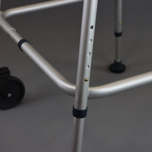 NRS Walk Safe Walking Frame showing adjustable holes and rubber tips, close-up view.