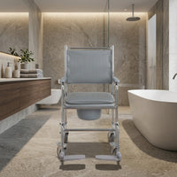 NRS wheeled commode with height-adjustable seat and footrests, shown in a modern bathroom setting, front view.