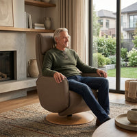 Man sitting in an Orla Riser Recliner Swivel Chair, an ergonomic powered mobility support riser with swivel capabilities, in use.