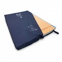 Partnership Active Mattress with zippered cover and grid-patterned foam, alternating cells, angled view.