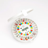 Pivotell Advance Automatic Pill Dispenser with round labelled compartments and digital display, front view.