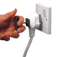 Homecraft Plug Pull pack of 3, key-shaped self-adhesive aid being used to remove a plug from an outlet, close-up in use.