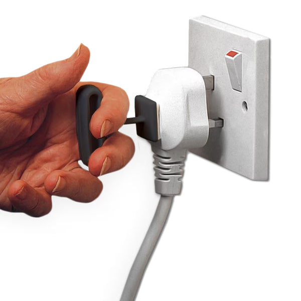 Homecraft Plug Pull pack of 3, key-shaped self-adhesive aid being used to remove a plug from an outlet, close-up in use.