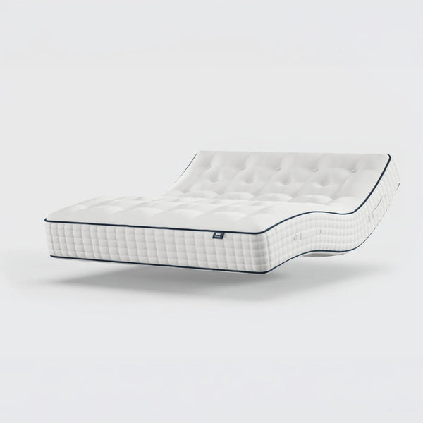 Opera Beds Premium Natural Pocket 2500 Mattress shown bending to display flexibility, plain background, side view.