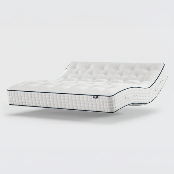 Opera Beds Premium Natural Pocket 2500 Mattress with tufted surface, reclined on plain background, angled side view.