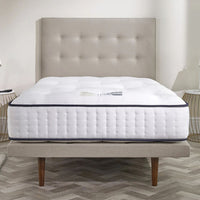 Opera Beds Premium Natural Pocket 2500 Mattress with tufted headboard and wooden legs, bedroom setting, front view.