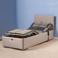 Restwell Richmond Electric Adjustable Bed Base with remote control in a carpeted room, angled view.