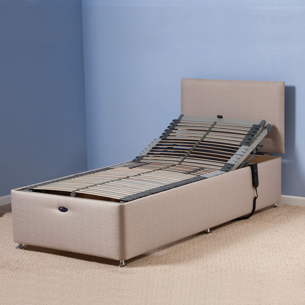 Restwell Richmond Electric Adjustable Bed Base with raised head, light blue wall and carpet, side view.