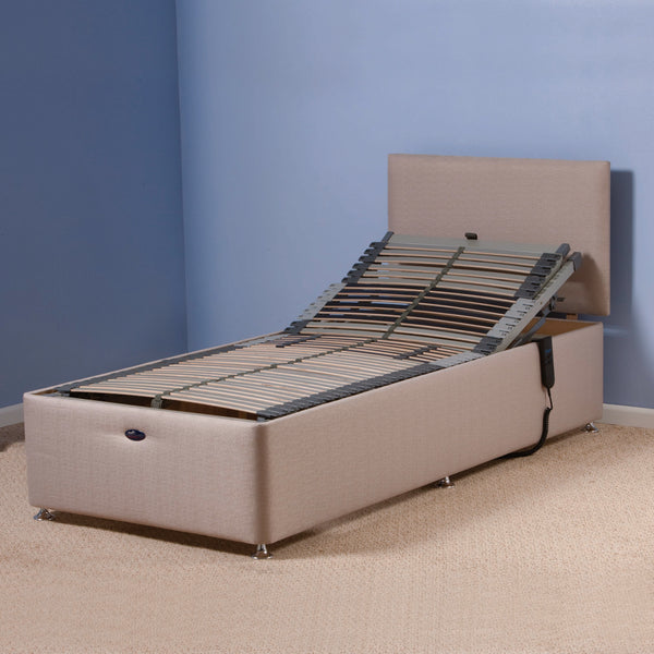 Restwell Richmond Electric Bed and Mattress Combo with head elevated in a blue-walled, beige-carpet room, side view.