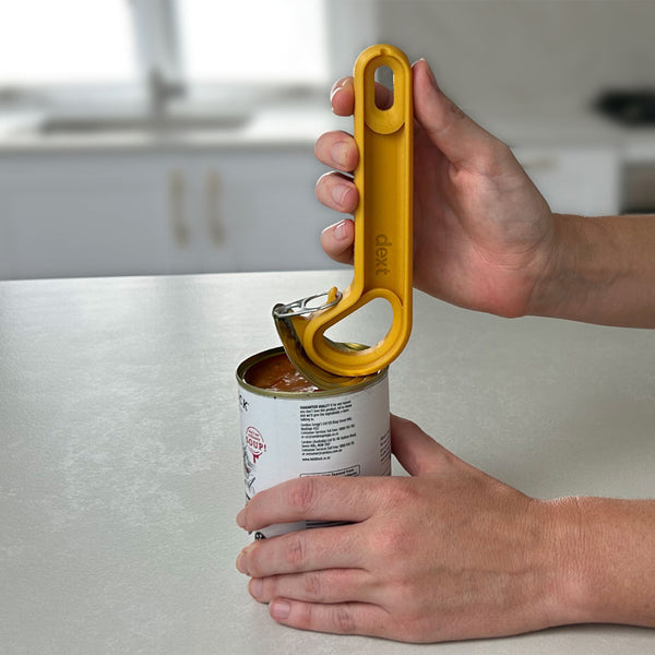 Easi-Grip Dext RingPull Can Opener in use opening a can on a kitchen counter, close-up.