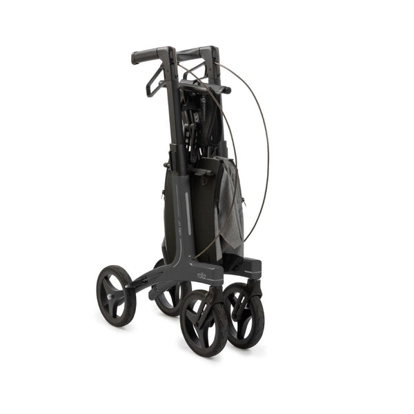 Rollz Air Carbon Fibre rollator in coal black, folded with seat and mesh bag visible, white background, side view.