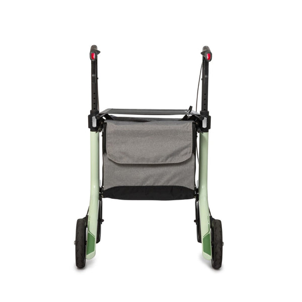 Mint green carbon fibre rollator with black handles and large grey storage bag, rear view.