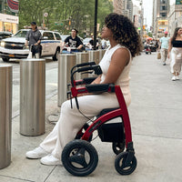 Rollz Motion Performance wheelchair in use by woman on city pavement, side view.