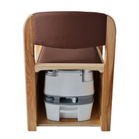 Royale Flushing Commode by Gordon Ellis with hardwood frame and cushioned seat, rear view on white background.