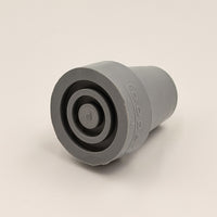 Coopers walking stick ferrule, cylindrical metal with flat face and raised centre for walking aids, close-up view.