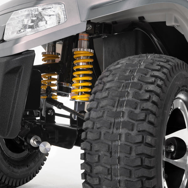 Drive Safari Scooter front suspension with yellow springs and large pneumatic tyres, close-up.