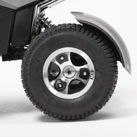 Drive Safari Scooter rugged pneumatic tyre, wheel, and all-round suspension under a curved fender, close-up.