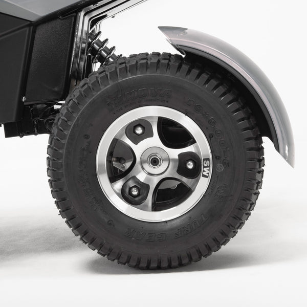 Drive Safari Scooter rugged pneumatic tyre, wheel, and all-round suspension under a curved fender, close-up.