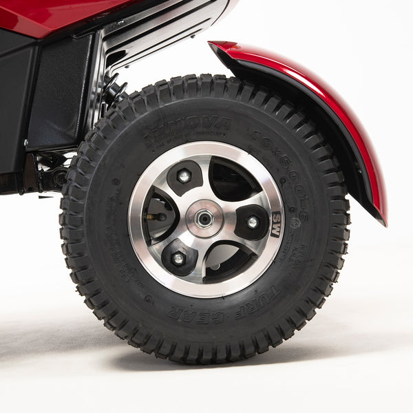 Drive Safari Scooter large pneumatic tyre with silver alloy wheel, white background, close-up.