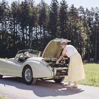 Saljol Bariatric Rollator next to a woman loading her car by a forest road, in use.