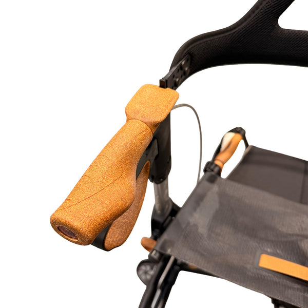 Ergonomic textured grip and integrated brake lever on a Saljol Carbon Rollator, close-up.