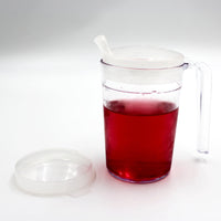 Homecraft shatterproof mug with handle, anti-spill spout lid, spare clear lid, filled with liquid, front view.