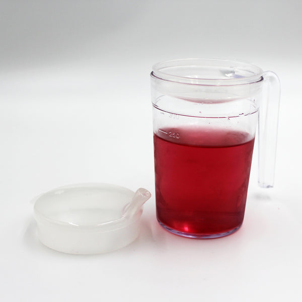 Homecraft Shatterproof Mug with handle, filled with liquid, next to detached anti-spill lid on white background, front view.