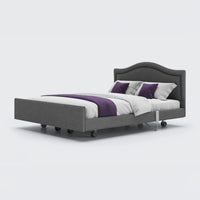 Opera Beds Signature Comfort Dual Profiling Bed with wheels, white bedding and purple accents on white background, front view.