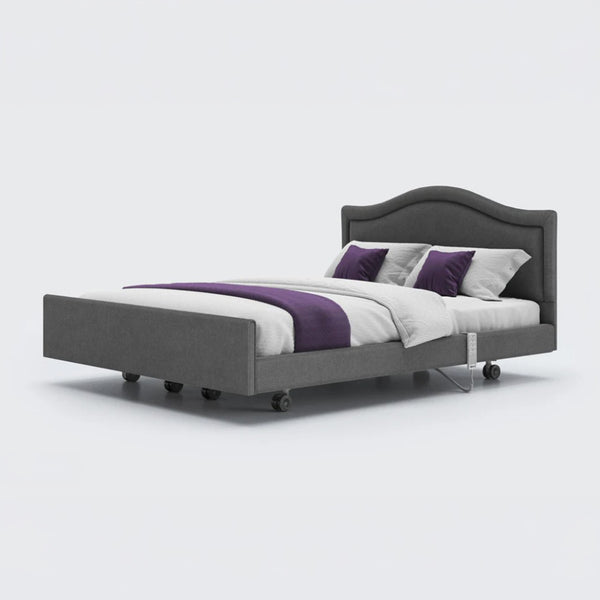 Opera Beds Signature Comfort Dual Profiling Bed with wheels, white bedding and purple accents on white background, front view.