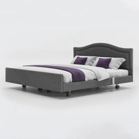 Opera Beds Signature Comfort Dual Profiling Bed with curved headboard and white bedding, front view.