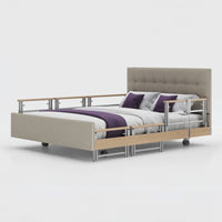 Opera Beds Signature Comfort Plus Dual Profiling Bed with linen upholstery, drop side rails and white bedding, purple accents, front view.