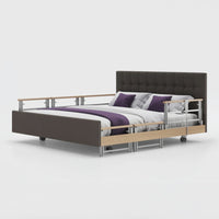Opera Beds Signature Comfort Plus Dual Profiling Bed with drop side rails, padded headboard and bedding, side view.