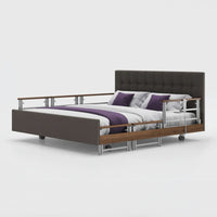 Signature Comfort Plus Dual Profiling Bed by Opera Beds with leatherette headboard and drop side rails, side view.