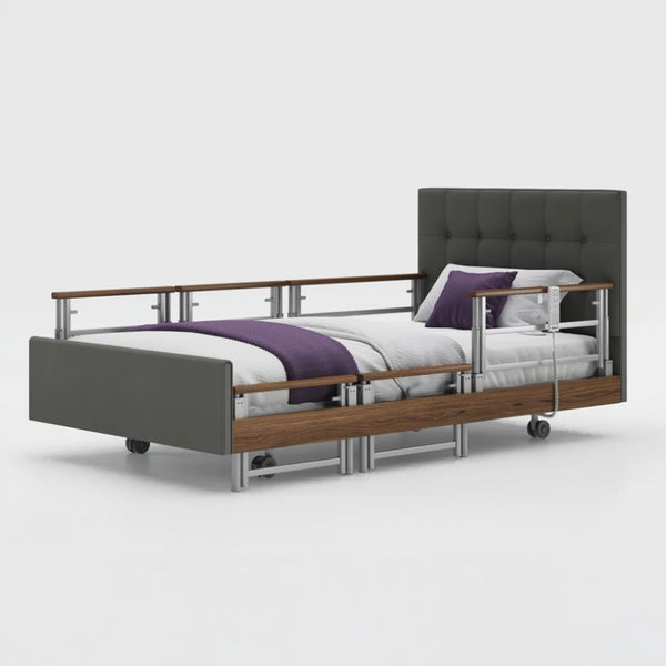 Opera Beds Signature Comfort Plus Profiling Bed with wood accents, side rails and wheels, side view.