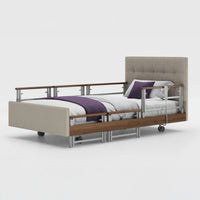Opera Beds Signature Comfort Plus Profiling Bed with white linens, purple blanket and pillow, beige fabric, side view.