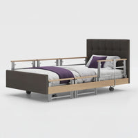 Opera Beds Signature Comfort Plus Profiling Bed with adjustable rails, leatherette frame and white bedding, side view.