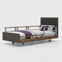 Profiling bed with leatherette frame, adjustable side rails, and wheels, front view.