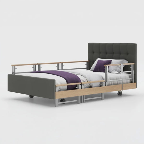 Opera Beds Signature Comfort Plus Profiling Bed with adjustable side rail, white bedding and purple blanket, side view.